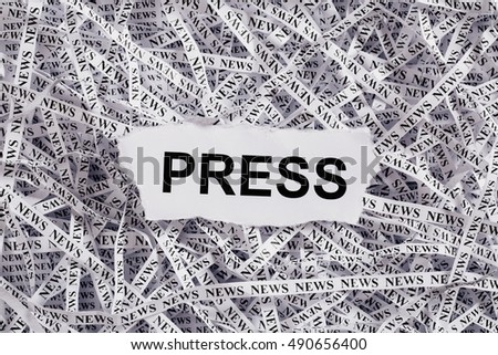 Closeup torn pieces and tapes of paper with the word PRESS. Black and White image. Concepts of money and business.