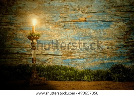 Christmas background, candlestick lit on old wooden background