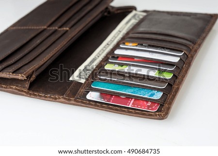 Brown leather wallet with money, credit and discount cards