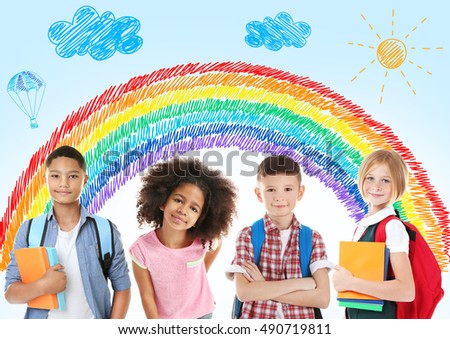 Group of cute children with drawings on background. School concept.