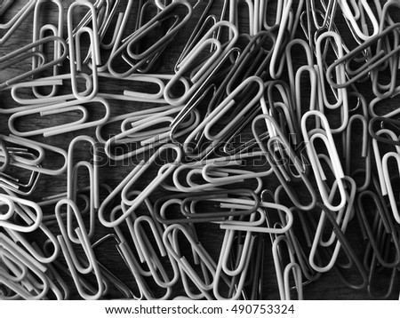 Close up groups of smile face paper clips, office supplies collection, abstract low key black and white background