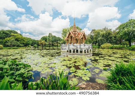 Beautiful landscape of the White Temple in Thailand pond with lotus leaf reflection on blue sky, Thailand.
