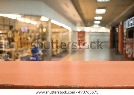 Wooden board empty table in front of blurred background. Perspective light wood over blur in shopping mall - can be used for display or montage