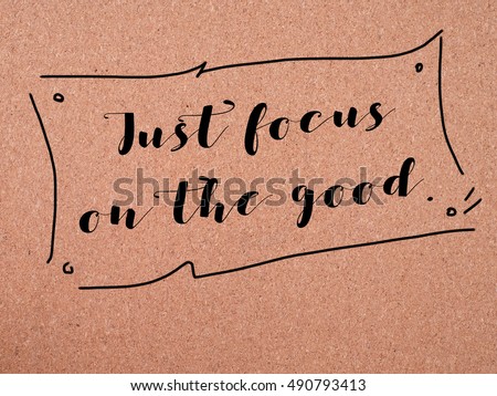 Inspirational life quote with phrase " Just focus o the good. " on wooden background.
