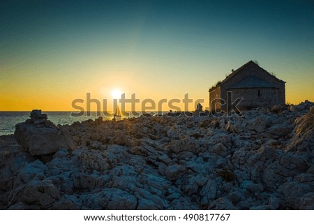 Little church in Razanj Croatia Europe. Beautiful nature and landscape photo of coastline in Dalmatia. Adriatic Sea at sunset, Lovely warm summer evening. Calm, peaceful and happy outdoors picture.