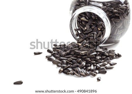 Sunflower Seeds in glass pot on white background. Helianthus annuus.
