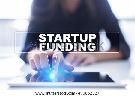 Woman is using tablet pc, pressing on virtual screen and selecting "Startup funding".