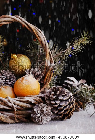 Christmas card decoration with fir branches, tangerines, pine cones, and decoration elements , selective focus