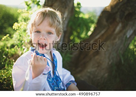 Cute little boy in traditional cloth outside