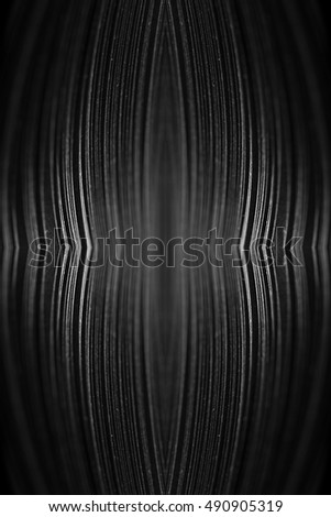 curled in a roll black paper ribbon like a fractal. Macro lens closeup shot 1:1