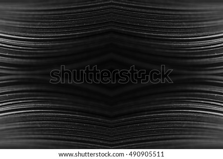 curled in a roll black paper ribbon like a fractal. Macro lens closeup shot 1:1