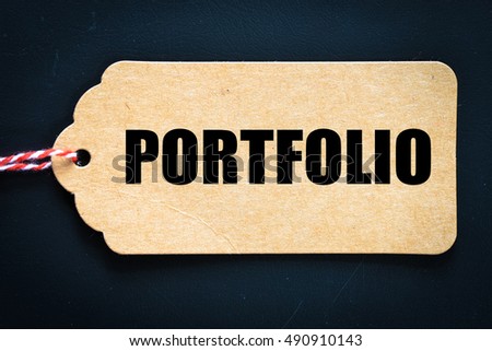 Portfolio. / Inscription portfolio on blank tags on wooden table 