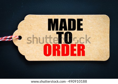 Made to order. / Inscription made to order on blank tags on wooden table 