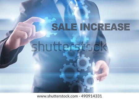 Businessman is selecting "Sale increase" on the virtual screen.
