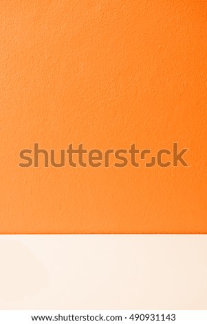 Orange plastering wall with white stripe, Thailand.