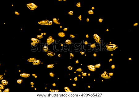 Air bubbles gold on a black background.