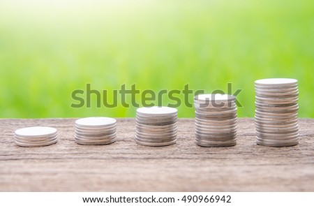 Baht Thailand coins placed on the wooden floor. Against the backdrop of green, Photo light.