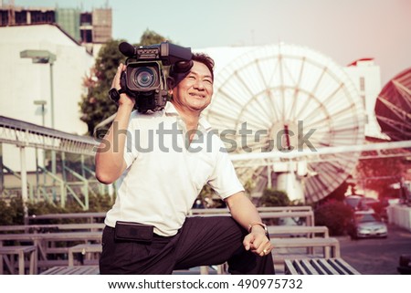 Portrait news cameraman broadcasting on satellite background, vintage color.