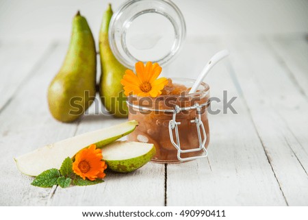 jam from a pear in a jar on a table, selective focus