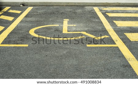 Disabled parking lot with disabled sign in yellow line