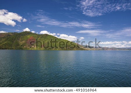 blue sky and clouds in Lake Toba,, with a beautiful view of the hills around Lake Toba,taken from ships

