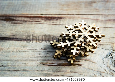 Snowflakes on wooden background. Winter holidays concept. Vintage toned.