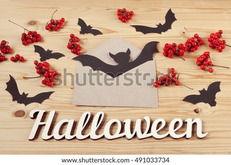 Halloween holiday background, text, berries and bats. View from above
