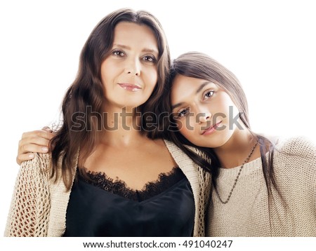 cute pretty teen daughter with mature mother hugging, fashion style brunette makeup close up, isolated on white background, lifestyle people concept