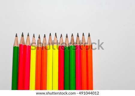 office desk with group of pencil,colorful of pencil on white paper, pencil make from wooden 