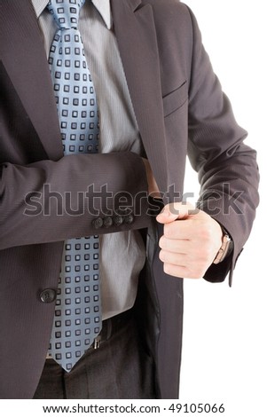 A businessman pulls something from his jacket pocket