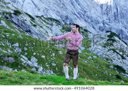 A traditional bavarian man on mountains in the background