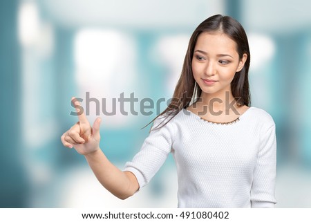 Businesswoman pressing button on visual screen