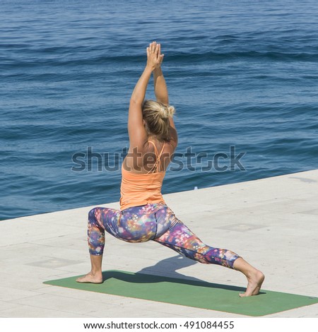 Zadar, Croatia. July 1, 2016. A girl doing yoga in front of the sea