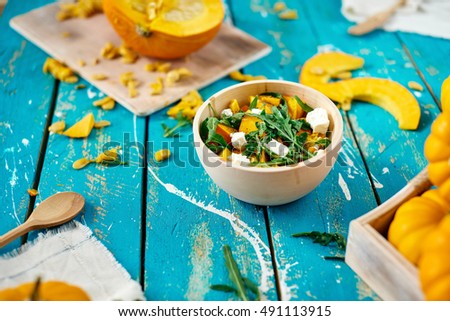 Healthy pumpkin salad with white cheese and arugula Royalty-Free Stock Photo #491113915