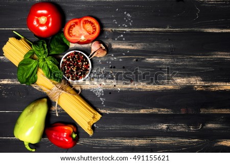 Food frame background Italian food, healthy food concept, or ingredients for making pasta on a dark wooden background with copy space, top view