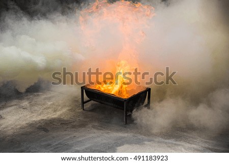 Burning of fire on a container filled with gasoline at firefighter's training