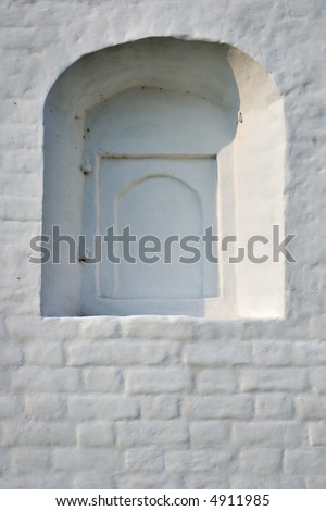 White wall with cloused window.