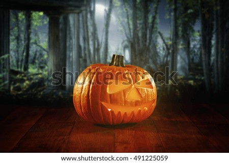 pumpkin on desk and halloween background 