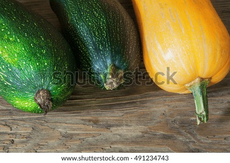 Vegetable marrows and pumpkin on a wooden table