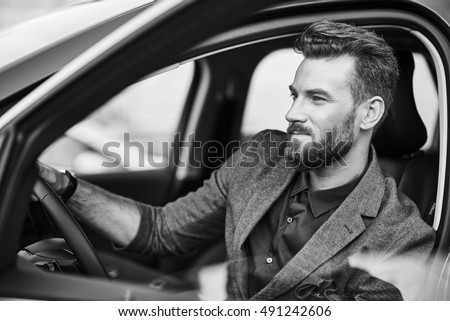 Portrait of handsome man in the car Royalty-Free Stock Photo #491242606