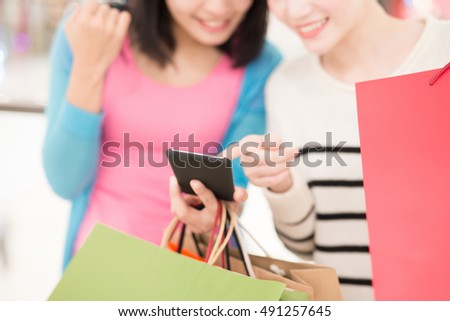 Happy women shopping in the mall, with phone, asian
