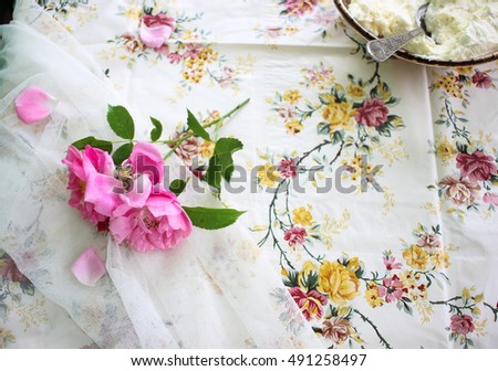 Pink tender flowers on summer outdoor dinner table closeup