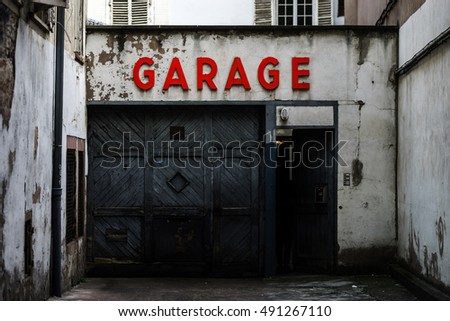 Old abandoned garage with red sign in historical center of Strasbourg