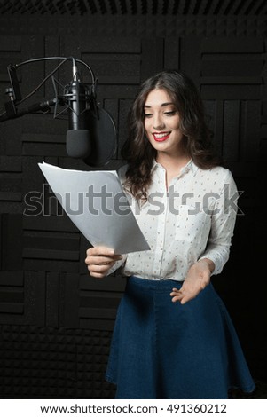 Pretty young woman in recording station
