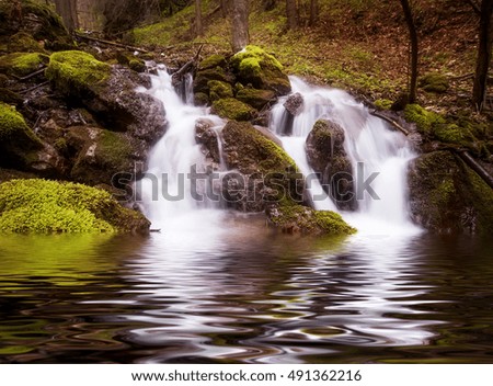 beautiful waterfall in the deep forest. natural background. vintage picture