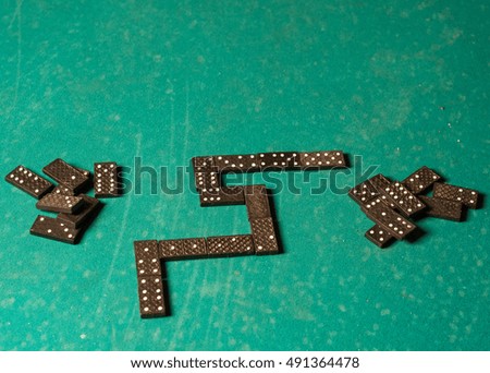 dominoes on a green table