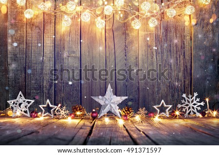 Vintage Christmas Decoration With Stars And Lights On Wooden Table

