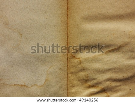 Old book open on both blank shabby pages with stains and scratches.