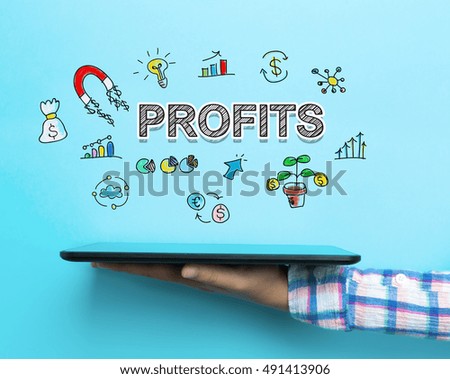 Profits concept with a tablet on blue background