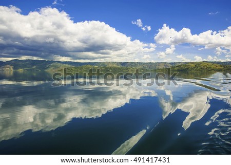 blue sky and clouds in Lake Toba,, with a beautiful view of the hills around Lake Toba,taken from ships